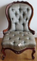 Early Victorian carved walnut framed low seated button back nursing chair. Approx. 90 x 56 x 50cms