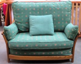Ercol mid 20th century oak spindle back two seater country style settee. Approx. 97 x 133 x 69cms