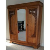 Early 20th century large oak three door mirrored wardrobe, with Art Nouveau style carving