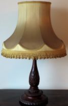 Early 20th century heavily carved mahogany table lamp, with shade. Approx. 52cms H reasonable used