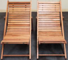 Pair of 20th century slatted folding wooden deck chairs reasonable used condition