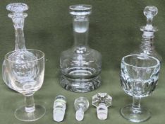 Early large stemmed drinking glass, another similar, plus thee glass decanters, spare stoppers,