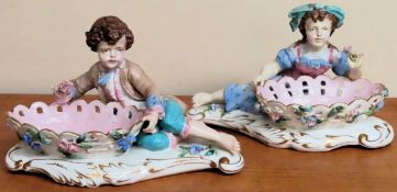 Pair of hand painted and gilded ceramic reclining figure form sweet dishes appear in reasonable used