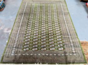 Large Middle Eastern style green decorative floor rug. Approx. 292cms x 191cms