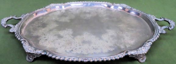 Large silver plated repousse decorated two handled serving tray on raised supports by S H & Co.