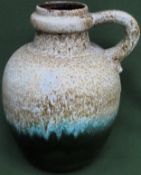 Mid 20th century West German glazed pottery loop handled jug. Approx. 39cms H reasonable used