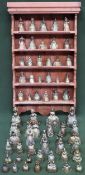 Quantity of various brass crinoline figure form bells, with stripped pine shelf rack
