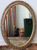 20th century gilded and piercework decorated oval wall mirror. Approx. 80 x 60cms