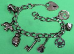 9ct gold charm bracelet set with seven 9ct gold charms and heart form clasp
