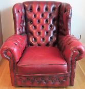 Vintage Ox Blood red leather button back wing armchair. Approx. 90 x 57 x 88cms