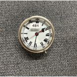 A silvered brass military wall clock dated 1945, Dia. 15cm.