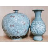 A Korean green crackle glazed and relief decorated water jug, H. 26cm. Together with a further green