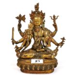 A Tibetan brass figure of a multi armed Tara inset with semi precious stones, H. 22.5cm.