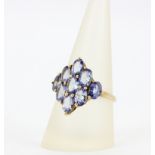 A hallmarked 9ct yellow gold ring set with large oval cut tanzanites, (S).