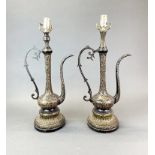 A pair of early 20th century Middle Eastern mounted, engraved and laquered brass jugs on ornate