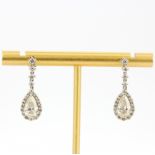 A pair of 18ct white gold pear shaped drop earrings each set with a pear cut diamond, approx. 1ct