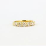 An 18ct yellow gold ring set with five brilliant cut diamonds, approx. 1.08ct total, (N).