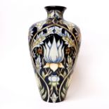 A 2005 Moorcroft tube lined bud vase decorated with an assortment of flowers, H. 24cm.
