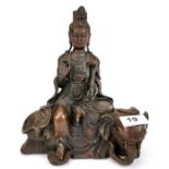 A Tibetan bronze figure of the Godess Guanyin seated on an elephant, H. 22cm.