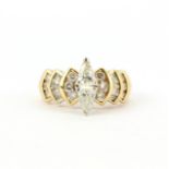 A 14ct yellow gold (stamped 14K) ring set with two trillion cut diamonds and baguette and