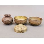 A Tibetan brass Ga'u (prayer box), H. 4cm, D. 9cm, together with two Indian brass bowls, and a