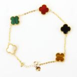 A 18ct gold clover bracelet set with onyx, malachite, chalcedony, tigers eye and mother of pearl, L.