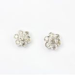 A pair of 18ct white gold daisy cluster earrings set with large brilliant cut diamonds, approx.