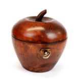 A carved wooden apple shaped tea caddy.