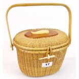 A wicker basket decorated with a bone whale and a bone clasp with bamboo handle, H. 16cm, L. 22cm.