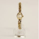 A ladies 9ct gold cased wrist watch, with expandable gold plated strap.