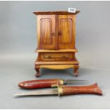 A miniature carved wooden cabinet, H. 38cm, together with a pair of interlocking carved wood and