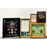 A frame of St John ambulance medals and badges with two frames of German military reproduction items