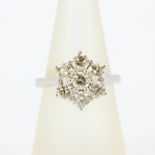 An 18ct white gold daisy cluster ring set with brilliant cut diamonds, approx. 2.16ct total, (O).