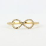 An 18ct yellow gold (stamped 750) infinity ring set with brilliant cut diamonds, (O).