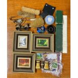 A group of small items, including opera glasses and small oil paintings.