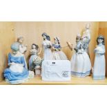 A collection of four porcelain Nao figures of girls, together with a Lladro collectors society