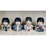 A group of Staffordshire pottery porcelain character jugs depicting The Beatles, tallest H. 13.5cm.