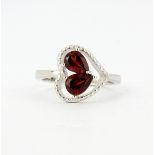 A 925 silver heart shaped ring set with pear cut garnets, (O).