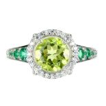 A 925 silver ring set with round cut peridot and emerald set shoulders, (N.5).