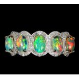 A 925 silver ring set with five oval cut opals and white stones, (N.5).
