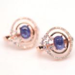 A pair of rose gold on 925 silver earrings set with cabochon cut sapphires and white stones, L. 1.