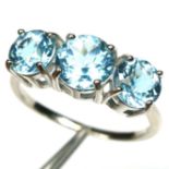 A 925 silver ring set with three round cut Swiss blue topaz, (P).