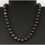 A stunning large black cultured pearl necklace with a 925 silver clasp, pearl size approx. 1cm, L.