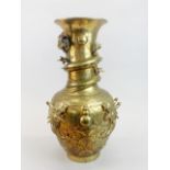 A large early 20th C Chinese polished brass/bronze vase relief decorated with a dragon, H. 42cm.