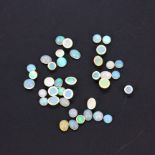 A quantity of unmounted natural oval cabochon opals, approx. 30.84ct total.