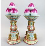 A pair of fine Chinese hand enamelled porcelain garnitures topped with peaches, H. 38cm.