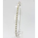 An 18ct white gold tennis bracelet set with brilliant cut diamonds, estimated approx. 7ct total,