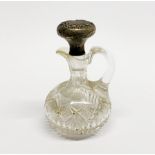 A Victorian cut crystal jug with white metal covered (tested silver) stopper.