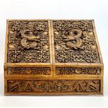 A Burmese carved wooden stationery box decorated with dragons, 36 x 29cm. Interior carved with the