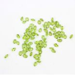 A quantity of unmounted natural oval and pear cut peridot, approx. 61.14 total.